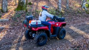 Driver on woodland road, front facing in white jacket. Avenger Red.