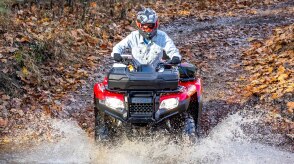 Front view of rider on Rancher going through muddy water.
