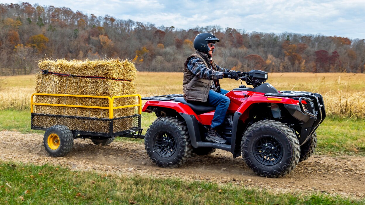 Person on Rubicon going right transporting hay in field.