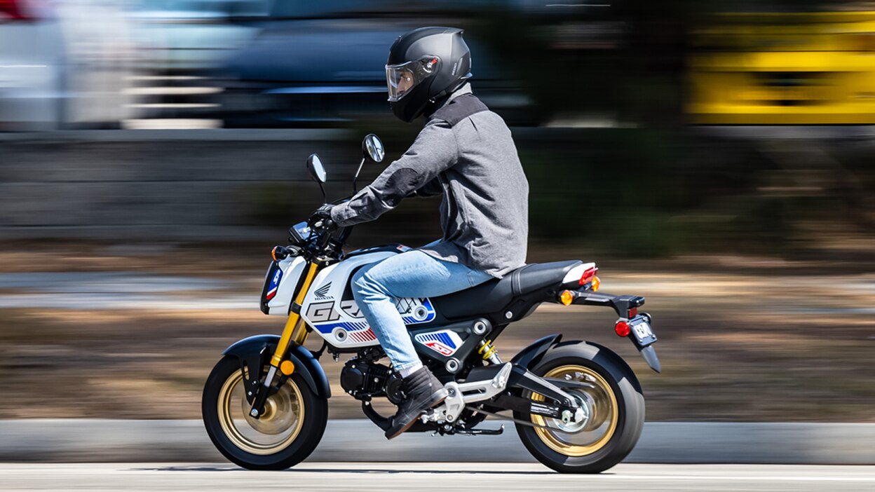 Rider on yellow bike going left on street.