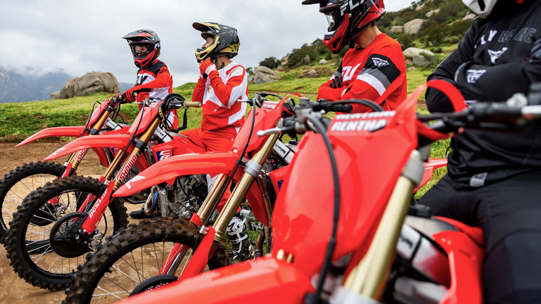 Close up of handles of four riders facing left.