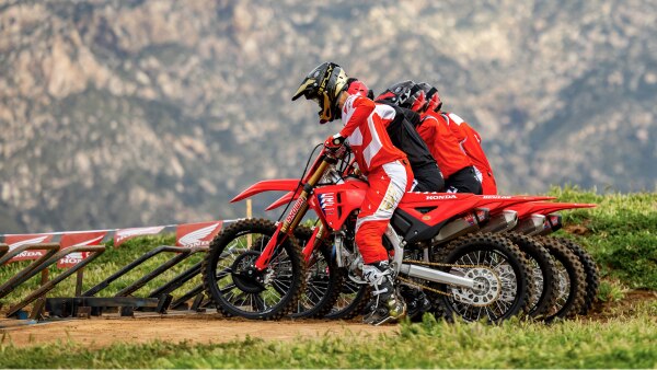 Four riders lined up on track facing left. Lifestyle.