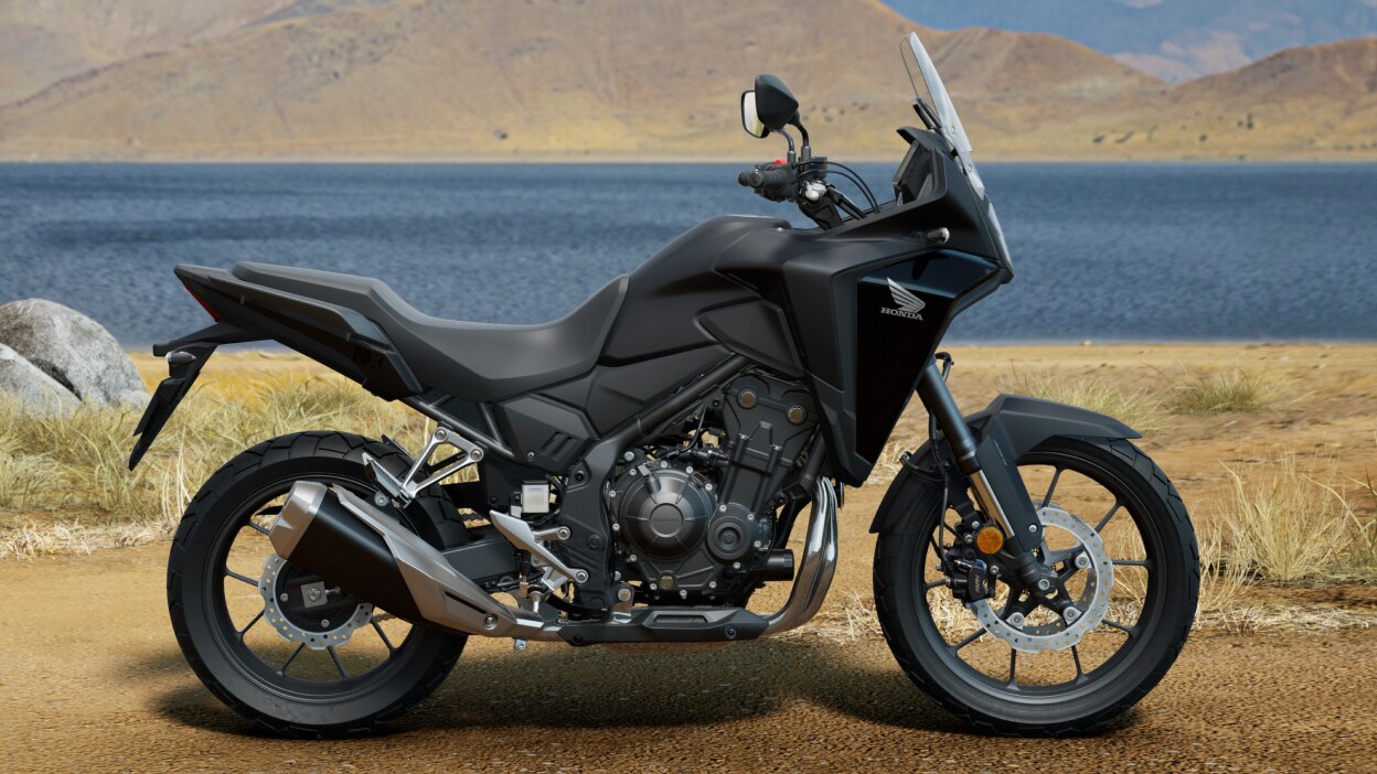 Right angle of NX500 on dirt road. Lake and hills in background.