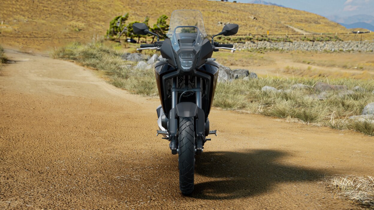 Front facing image of NX500 on dirt road.  Hill in background.
