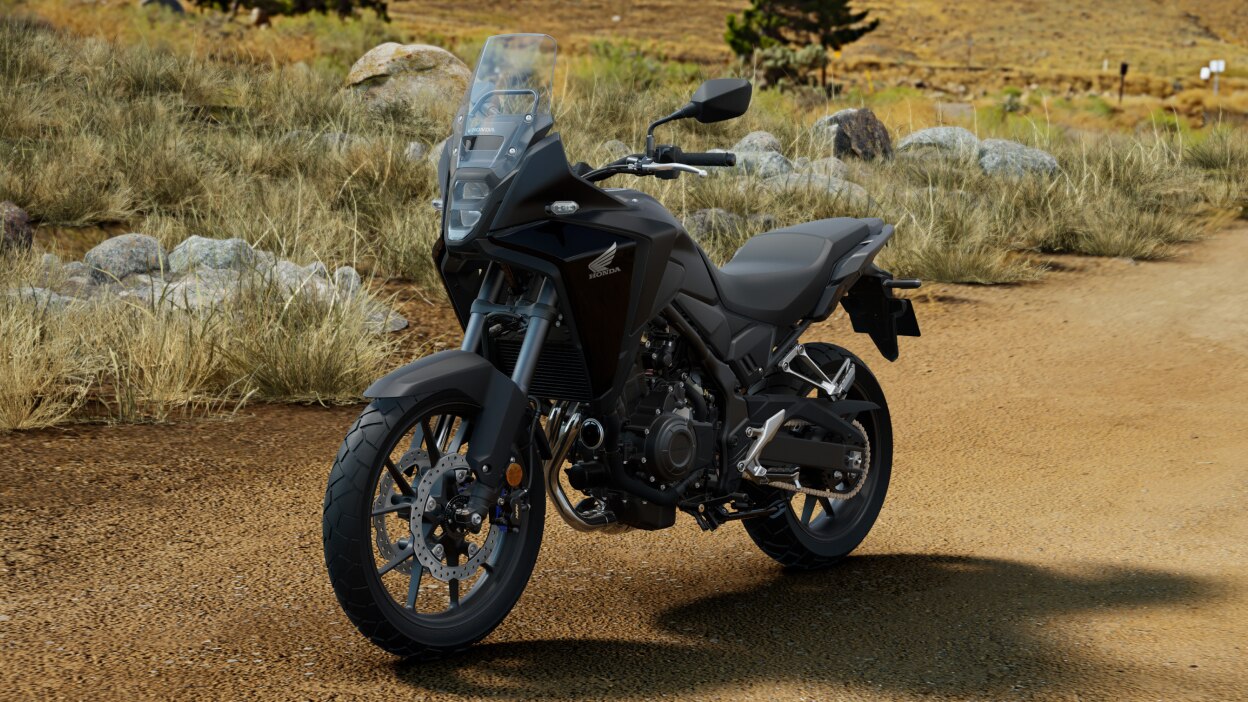 Left angle of NX500 on dirt road. Patches of grass and rocks in background.