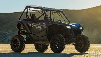 Talon stationary at right angle in desert landscape. Hill in background.